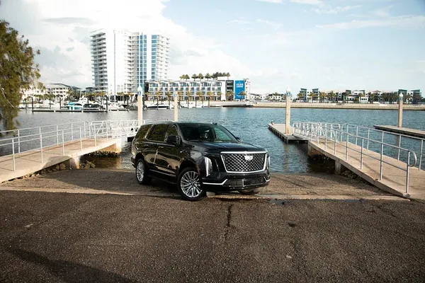 Black Cadillac Escalade waiting at a marina